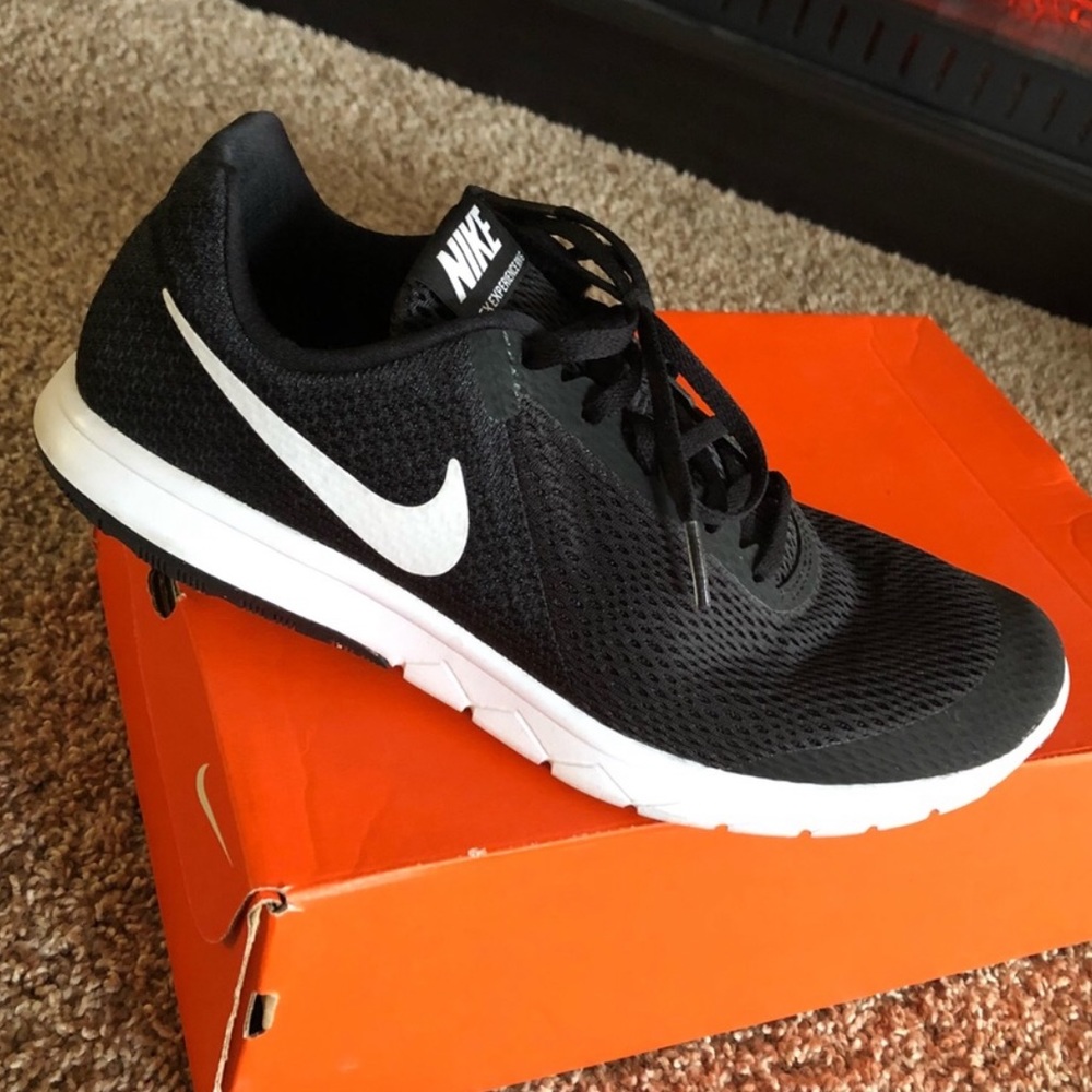 Black Nike Flex athletic shoes with white accent.